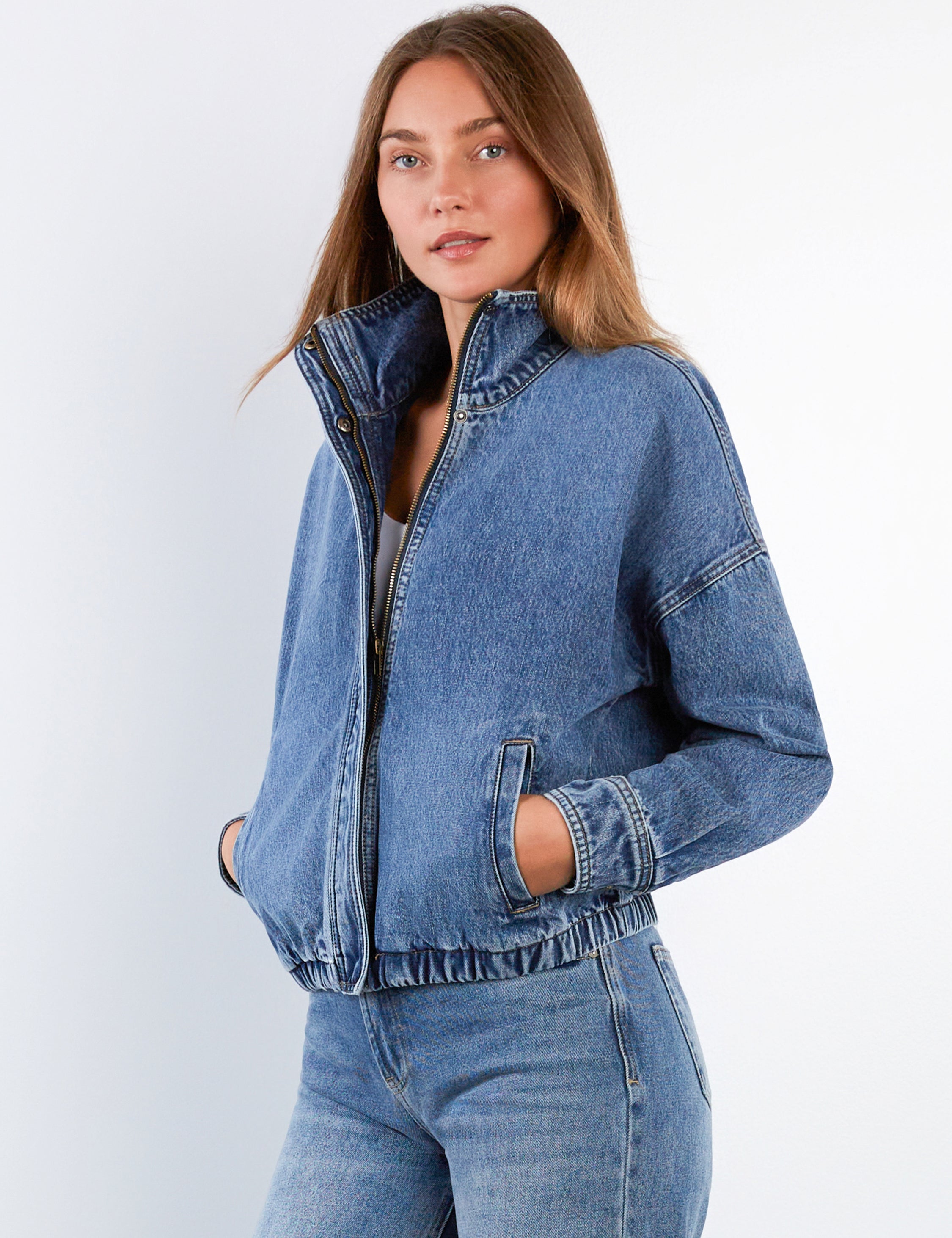 Woman wearing a blue denim bomber jacket