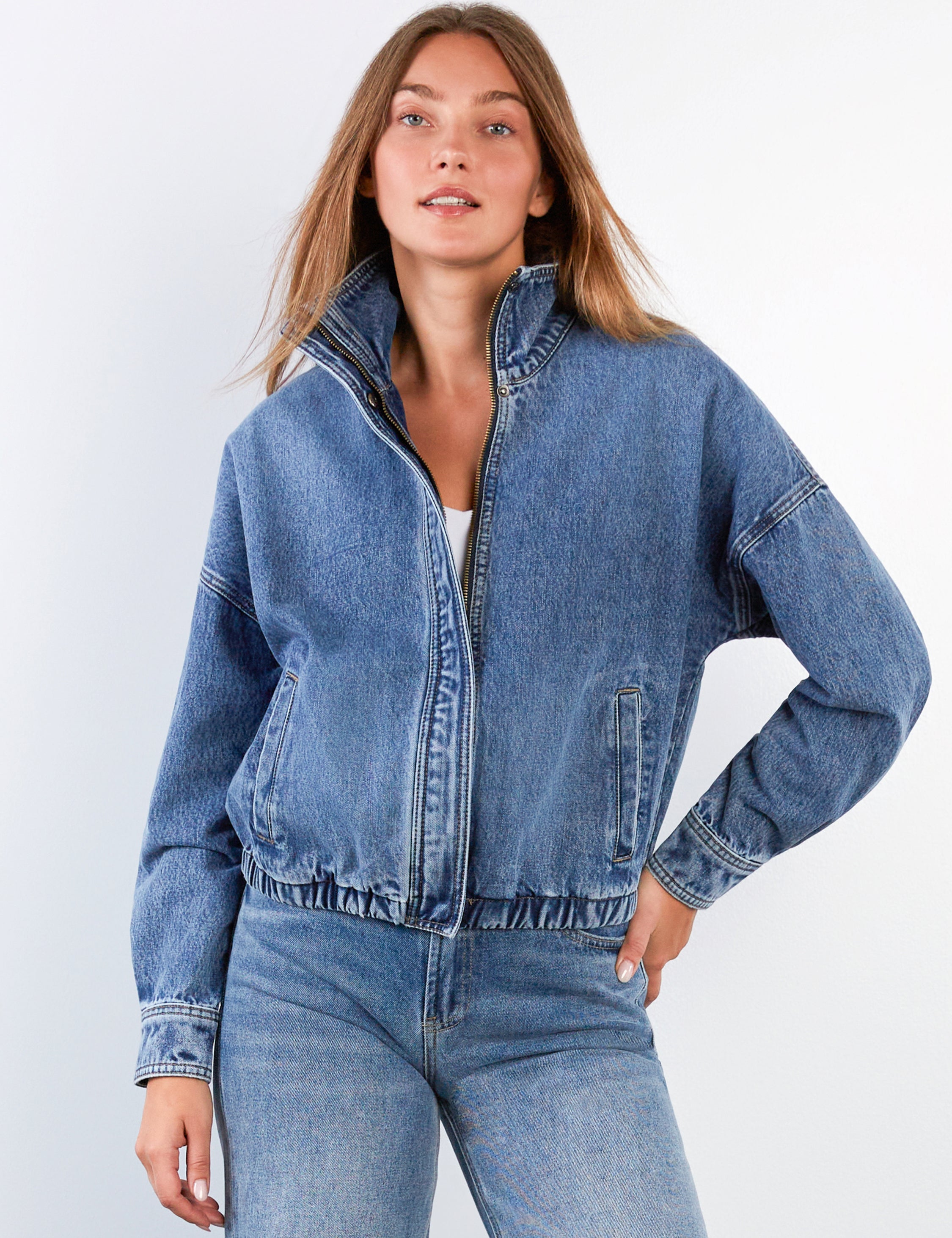 Woman wearing a blue denim bomber jacket